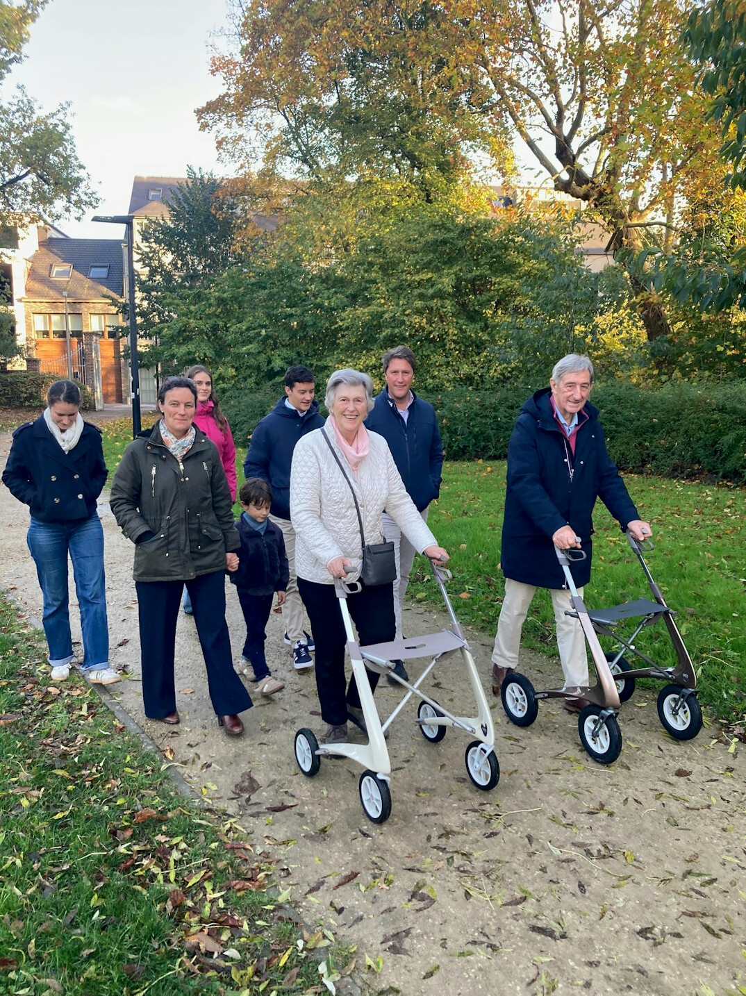 elderly friends walking in park