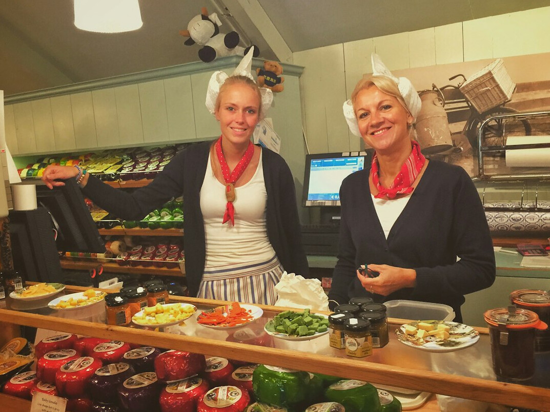 Elderly friends cooking together in a community kitchen