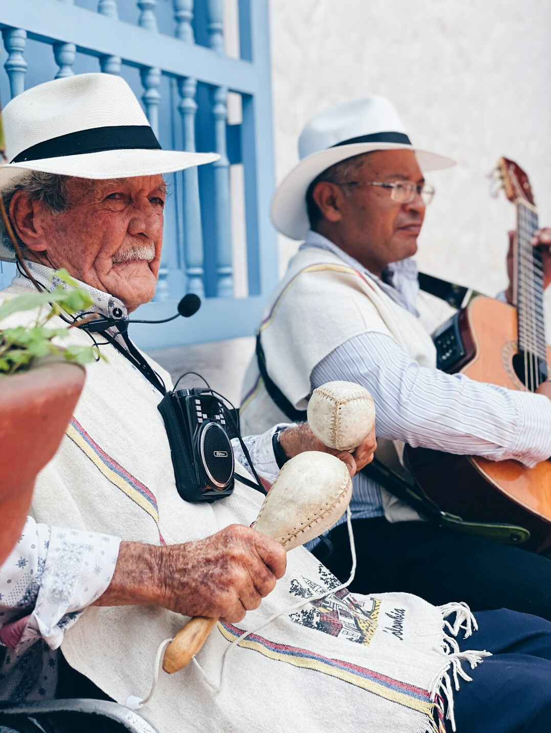 Elderly friends singing and playing music together in a community room