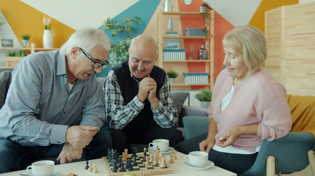 Cozy community room with tea cups and a board game on a wooden table